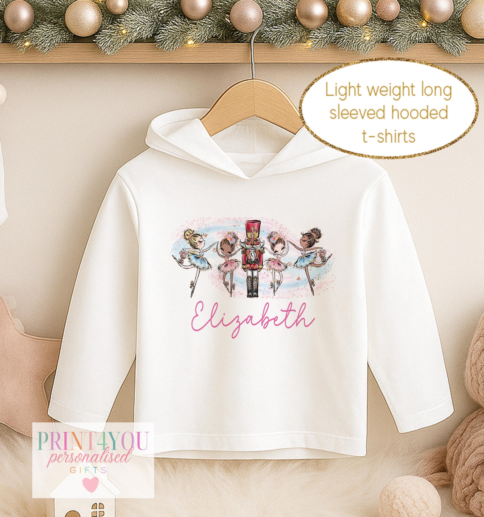 Personalised Christmas hooded t-shirt, white lightweight long sleeved hoodie printed with a nutcracker soldier and two ballerinas and a name