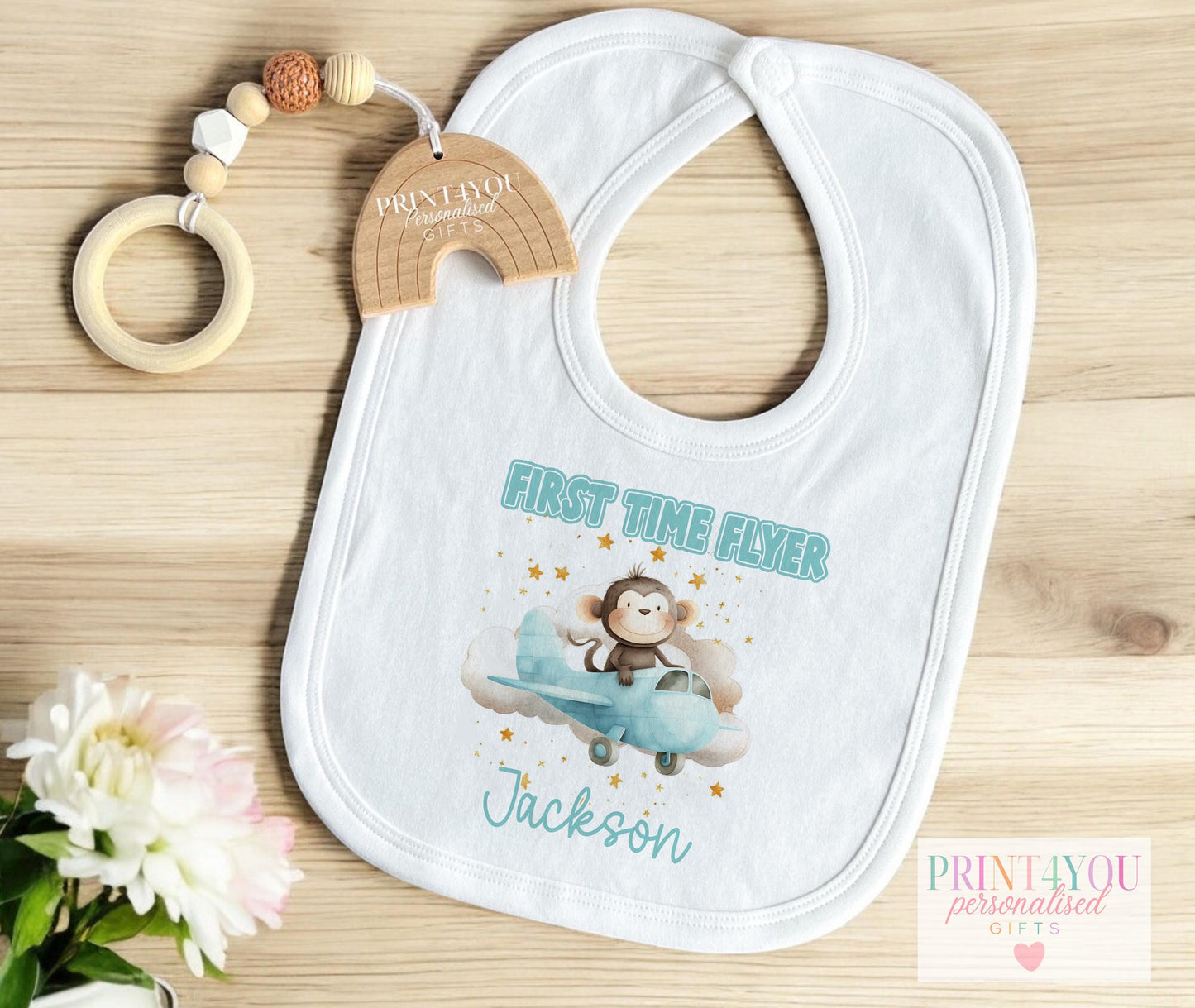 Close-up of the monkey and aeroplane design on the personalised baby vest.