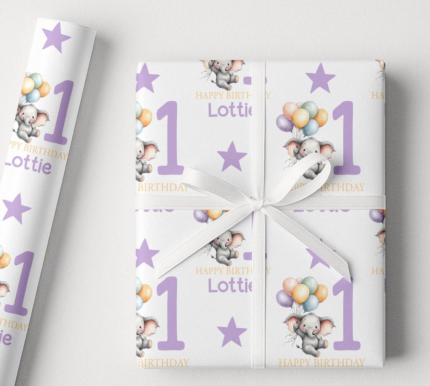 Close-up of the elephant and balloon pattern on the personalised purple birthday wrapping paper.