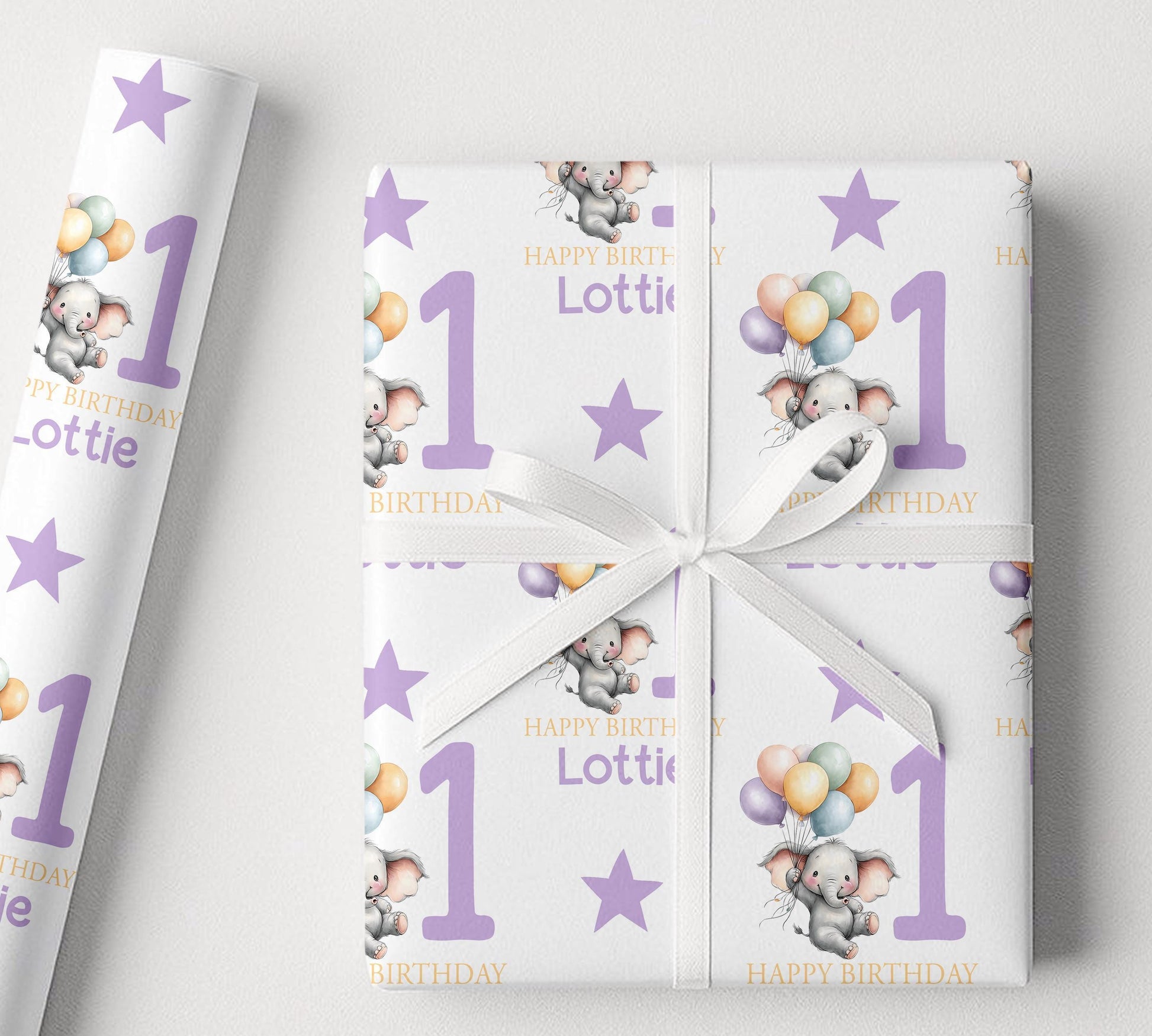 Close-up of the elephant and balloon pattern on the personalised purple birthday wrapping paper.