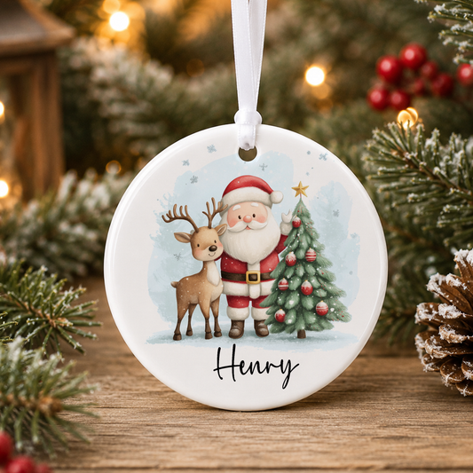 A white ceramic ornament with a Santa Claus and reindeer illustration, with the name "Henry" written below the image.