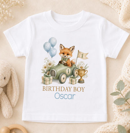 White cotton t-shirt printed with a watercolour fox driving a sage green race car with a number one, with Birthday Boy above a name