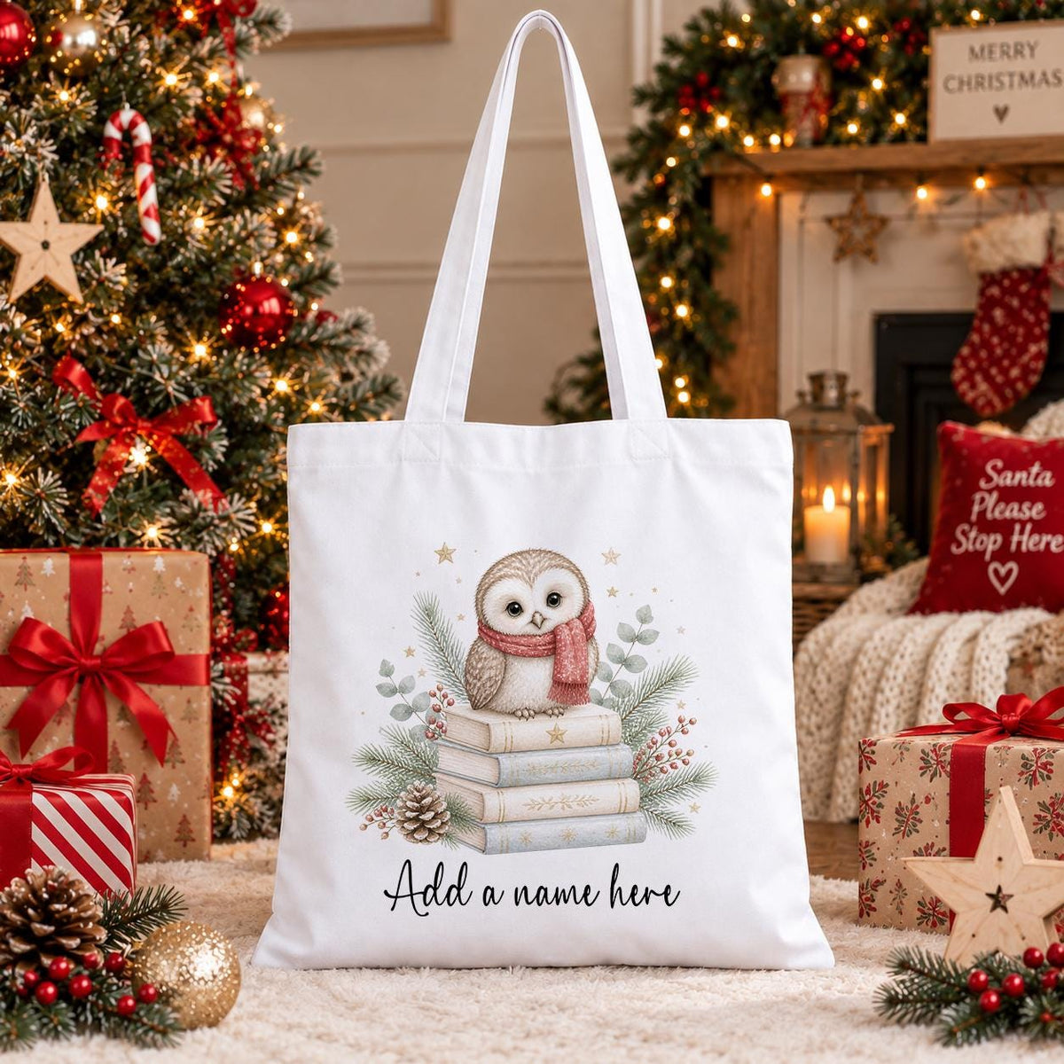 Personalised Christmas tote bag in white cotton with a cream owl in a pink scarf on a stack of books, pine and berries, with a name beneath