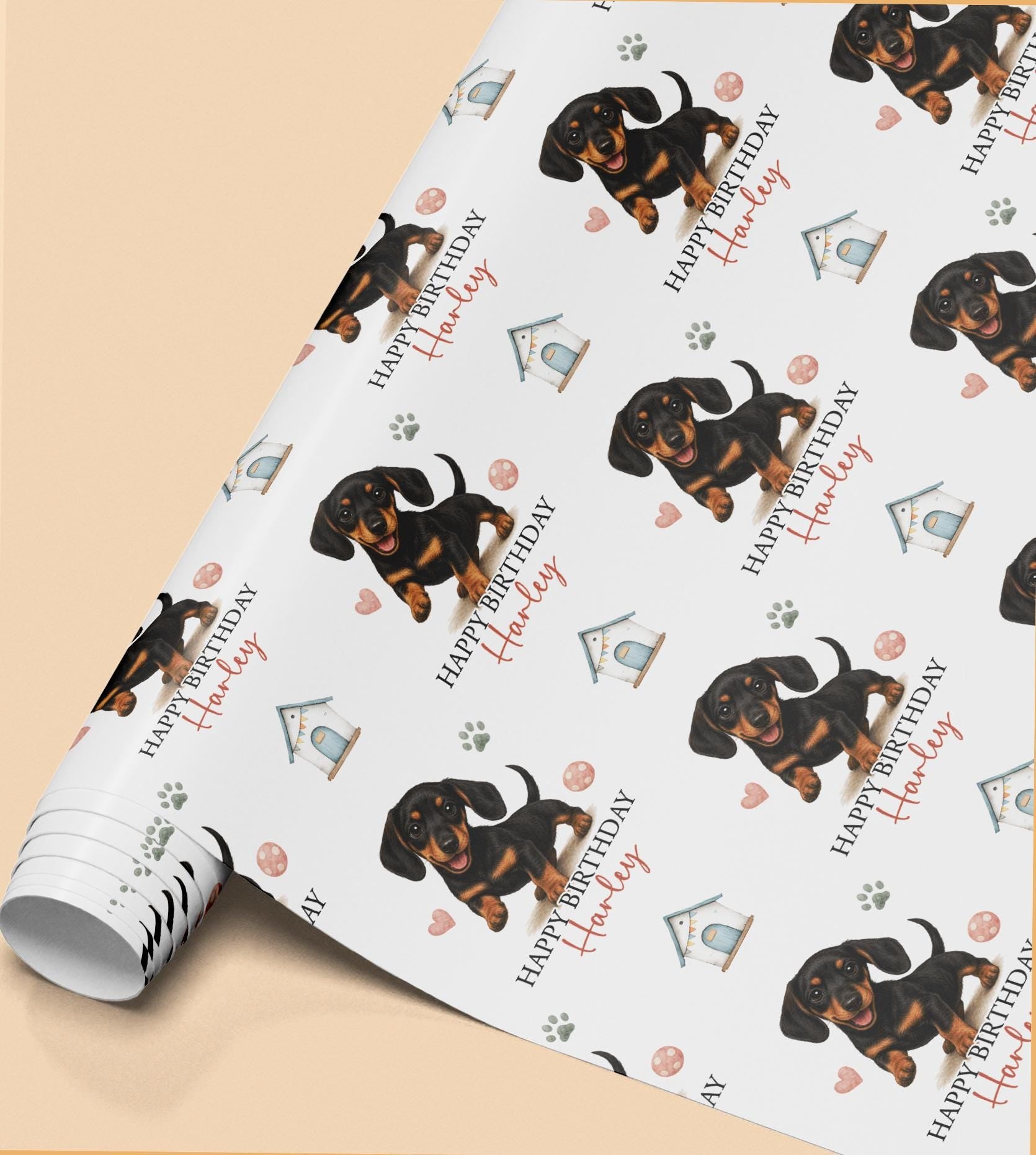 Personalised Dachshund birthday wrapping paper featuring a cute black and tan sausage dog puppy, custom name and birthday message with paw prints and dog toys.