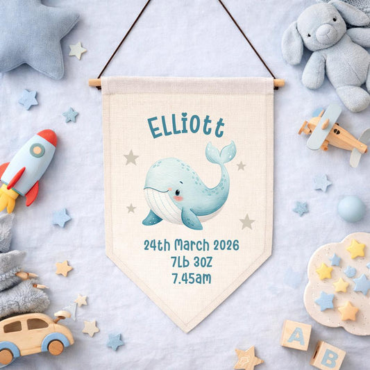 Ocean-themed personalised whale baby name flag with birth stats for nursery decor