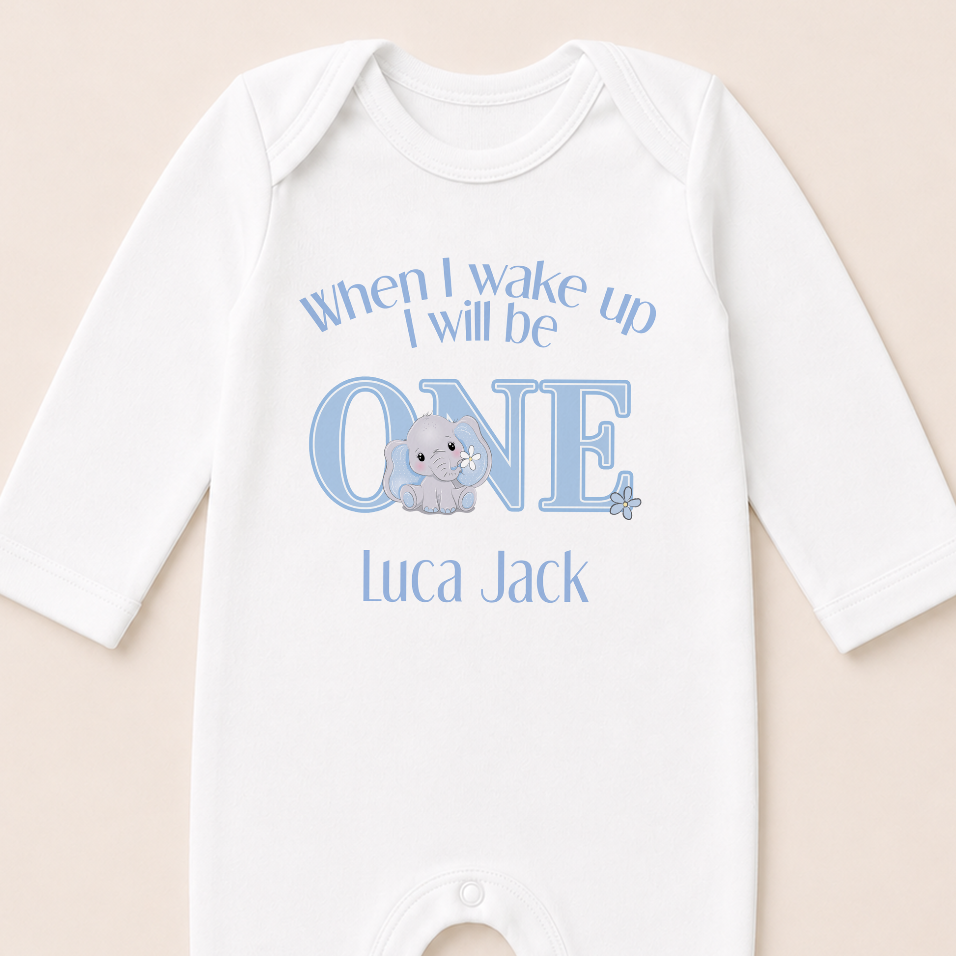 Personalised blue elephant sleepsuit printed with the "When I Wake Up I Will Be One" message and baby's name.