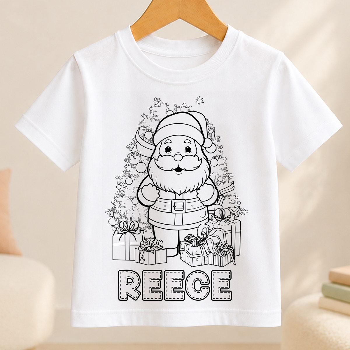 A white t-shirt with a black and white illustration of a smiling Santa Claus surrounded by presents and a Christmas tree. The name "REEBE" is written below the illustration.