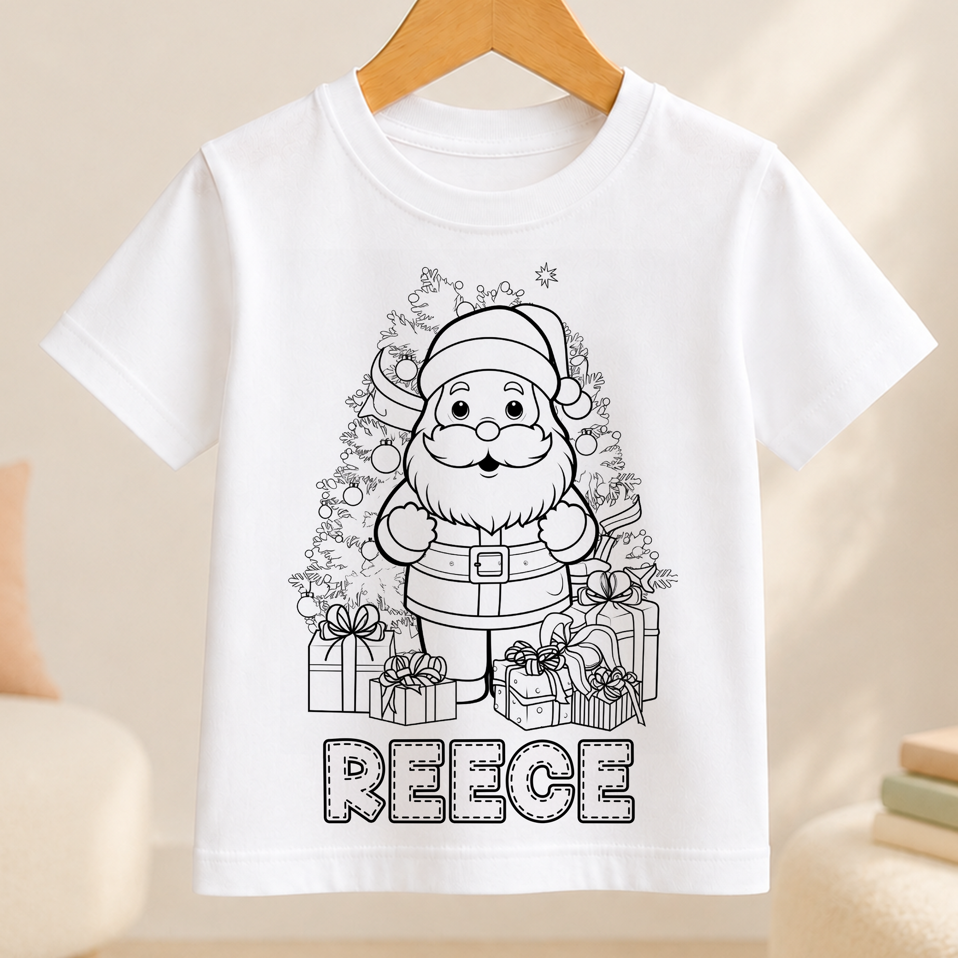 A white t-shirt with a black and white illustration of a smiling Santa Claus surrounded by presents and a Christmas tree. The name "REEBE" is written below the illustration.