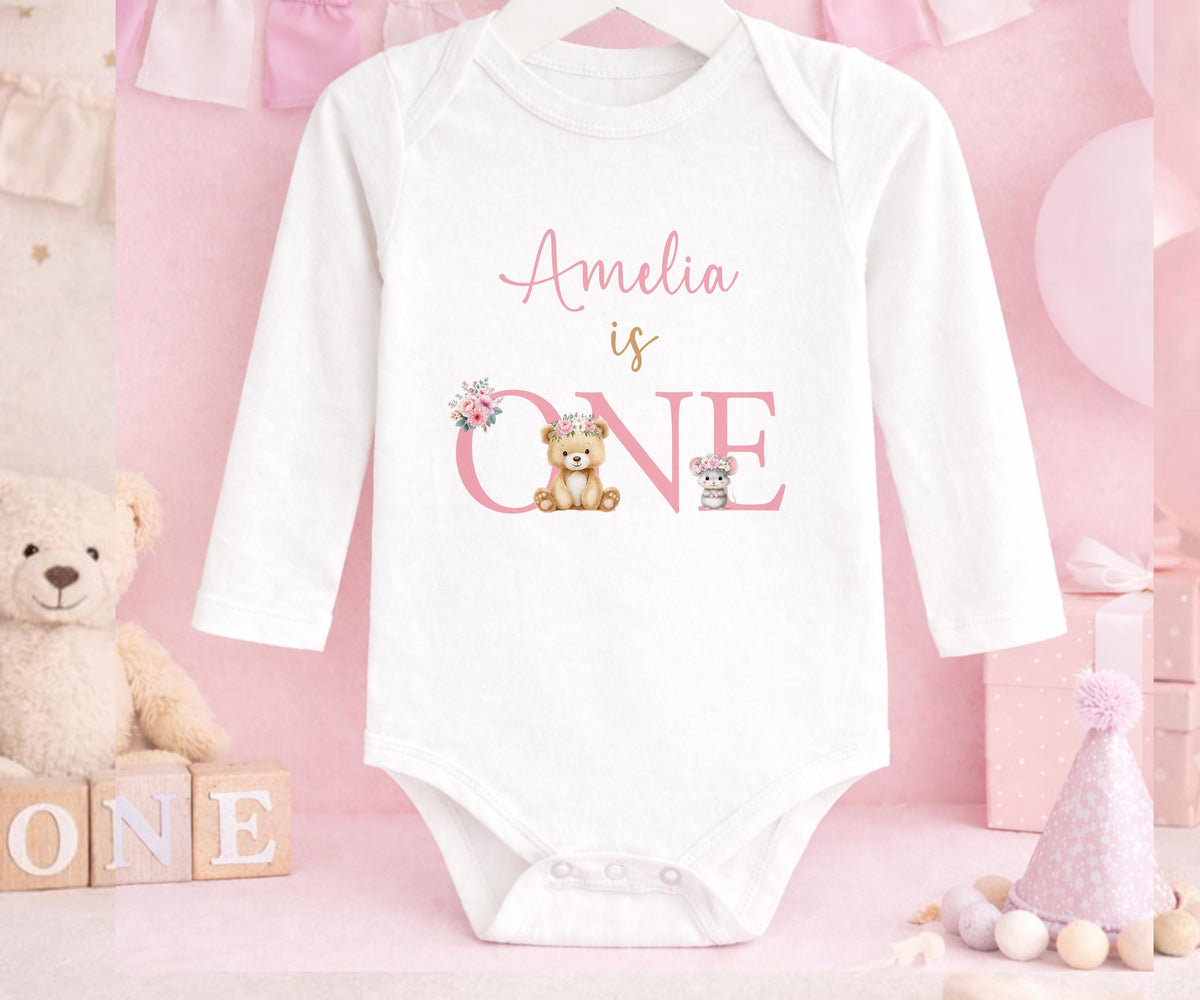 Personalised first birthday long sleeved vest with floral teddy bear design and custom name