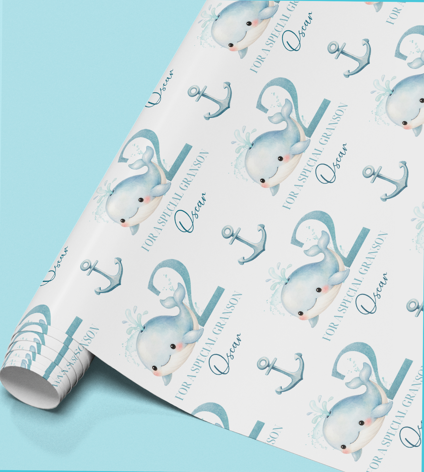 Flat lay of the personalised whale birthday wrapping paper showing the repeat whale and anchor pattern