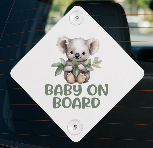 Diamond-shaped aluminium car window sign with a koala bear holding a leaf and the text Baby on Board