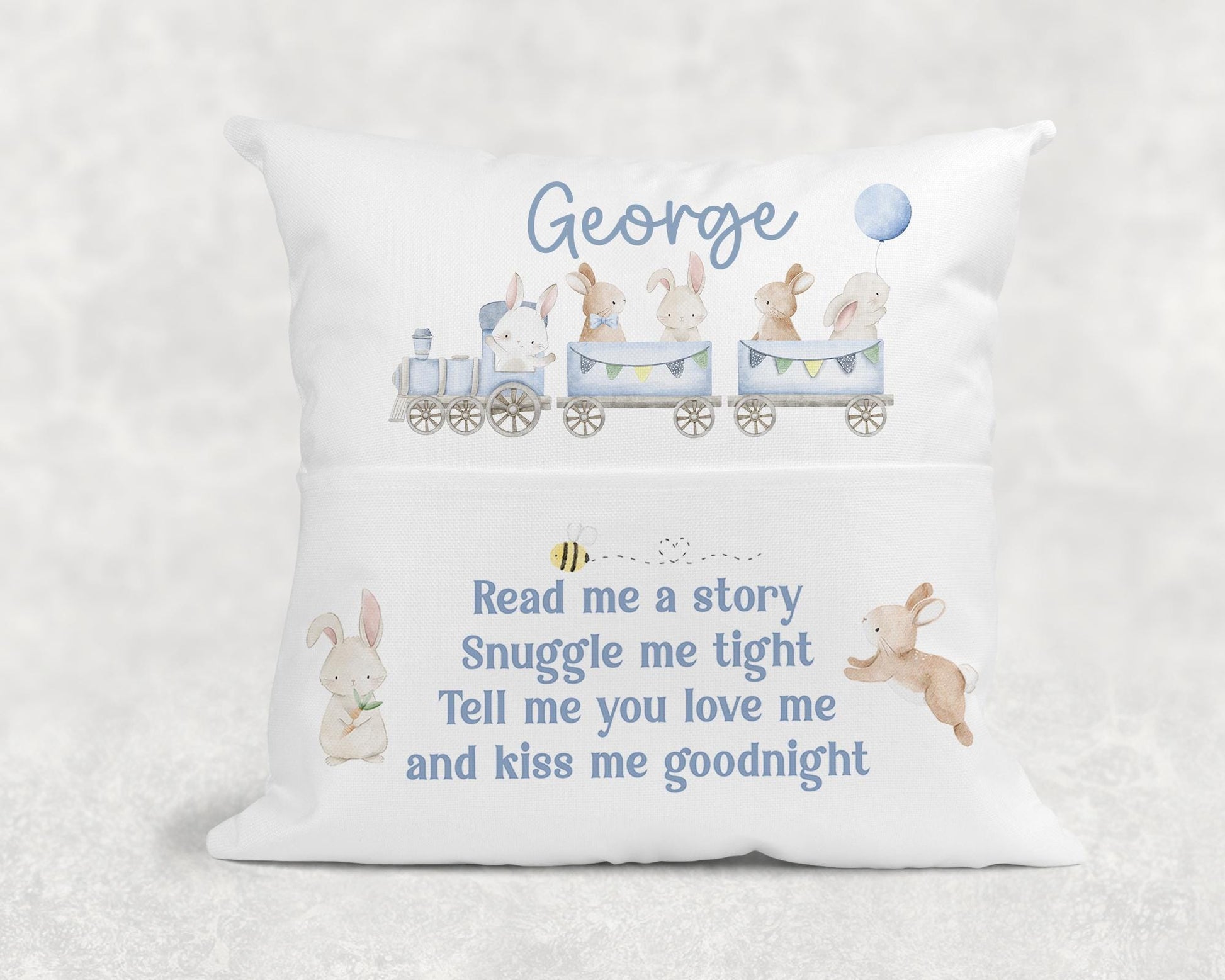 Personalised children's book cushion with blue train design propped on a chair