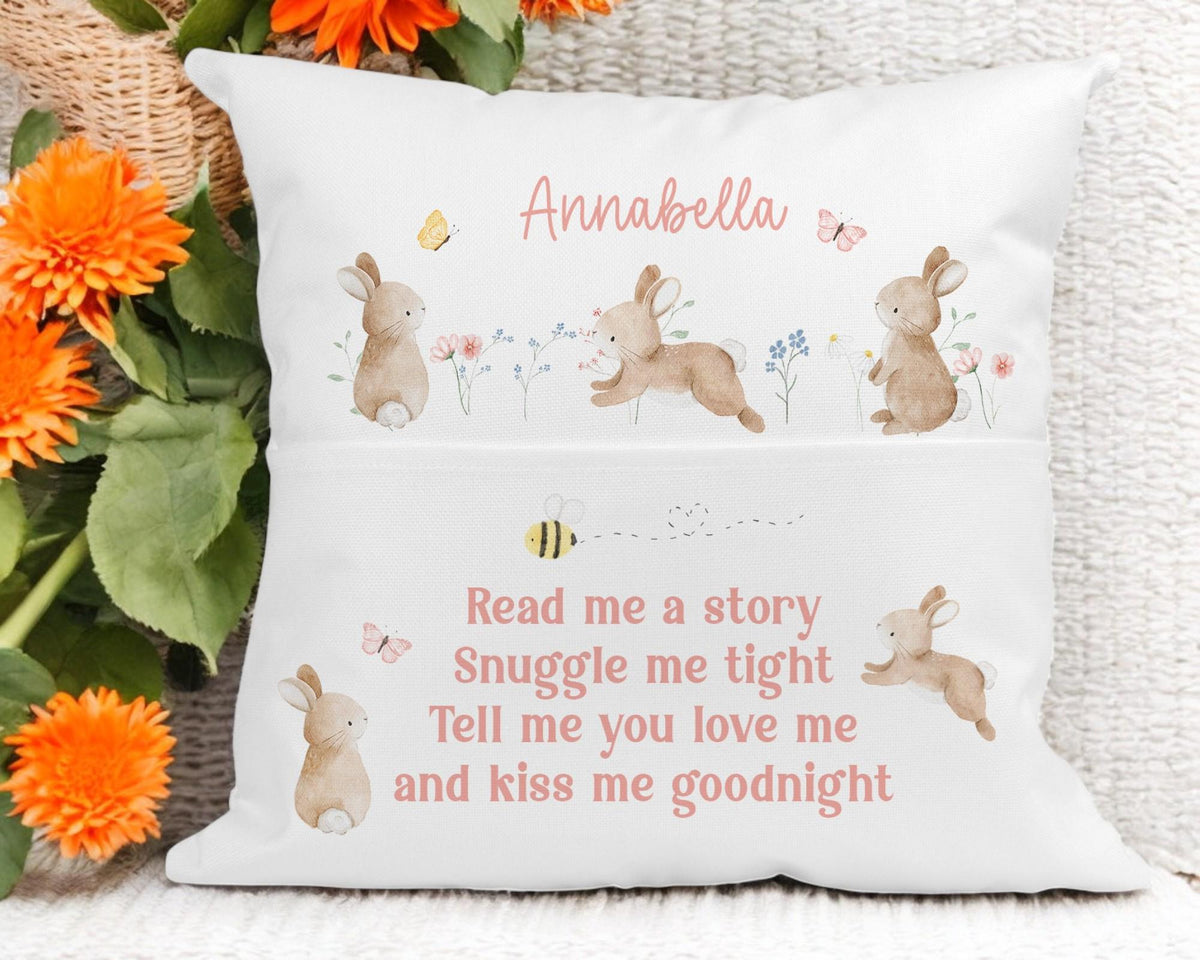 Close-up of personalised bunny book cushion showing custom name printed on the front pocket