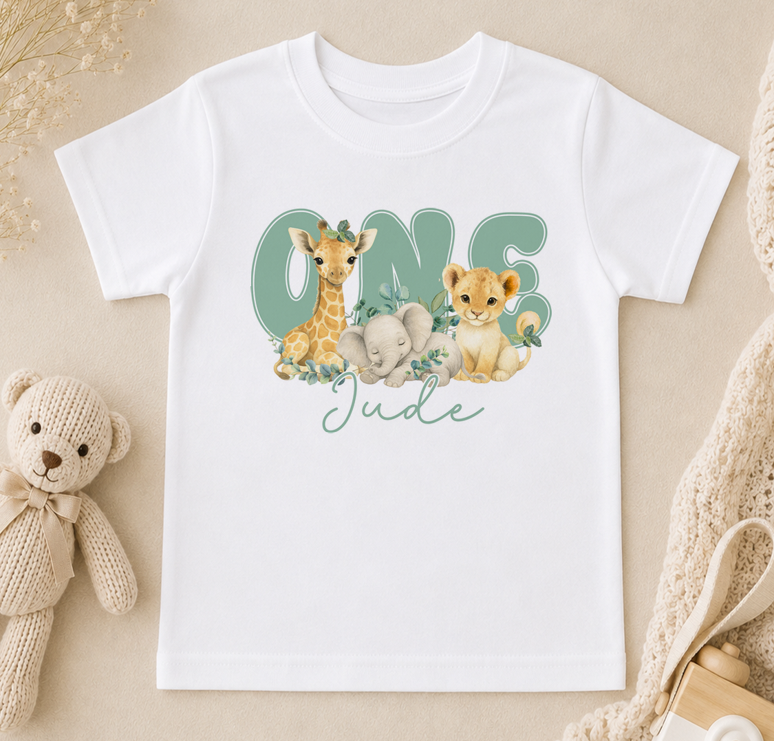 A white t-shirt with a graphic design featuring a giraffe, elephant, and lion, along with the text "One Jude" written on it.