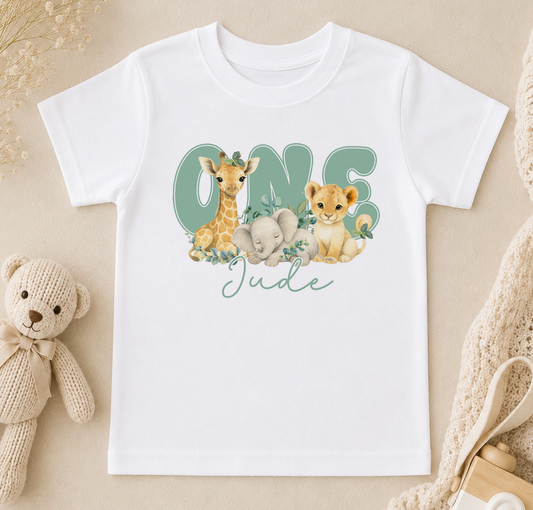 A white t-shirt with a graphic design featuring a giraffe, elephant, and lion, along with the text "One Jude" written on it.