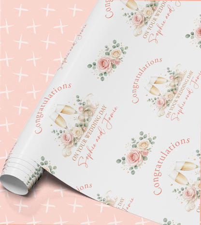 Personalised wedding day wrapping paper roll with champagne glasses, pink roses and the names Sophie and Jamie