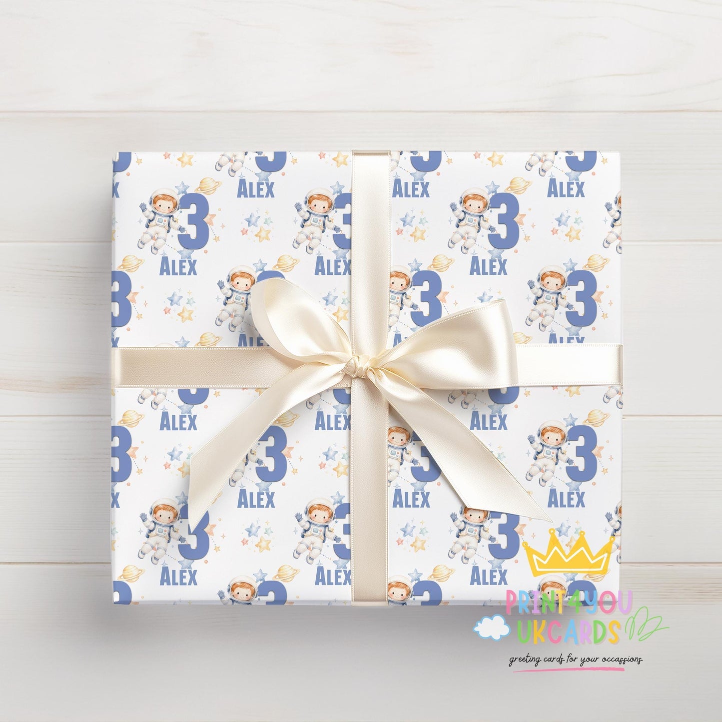 Gift wrapped in the personalised astronaut space wrapping paper, tied with ribbon.