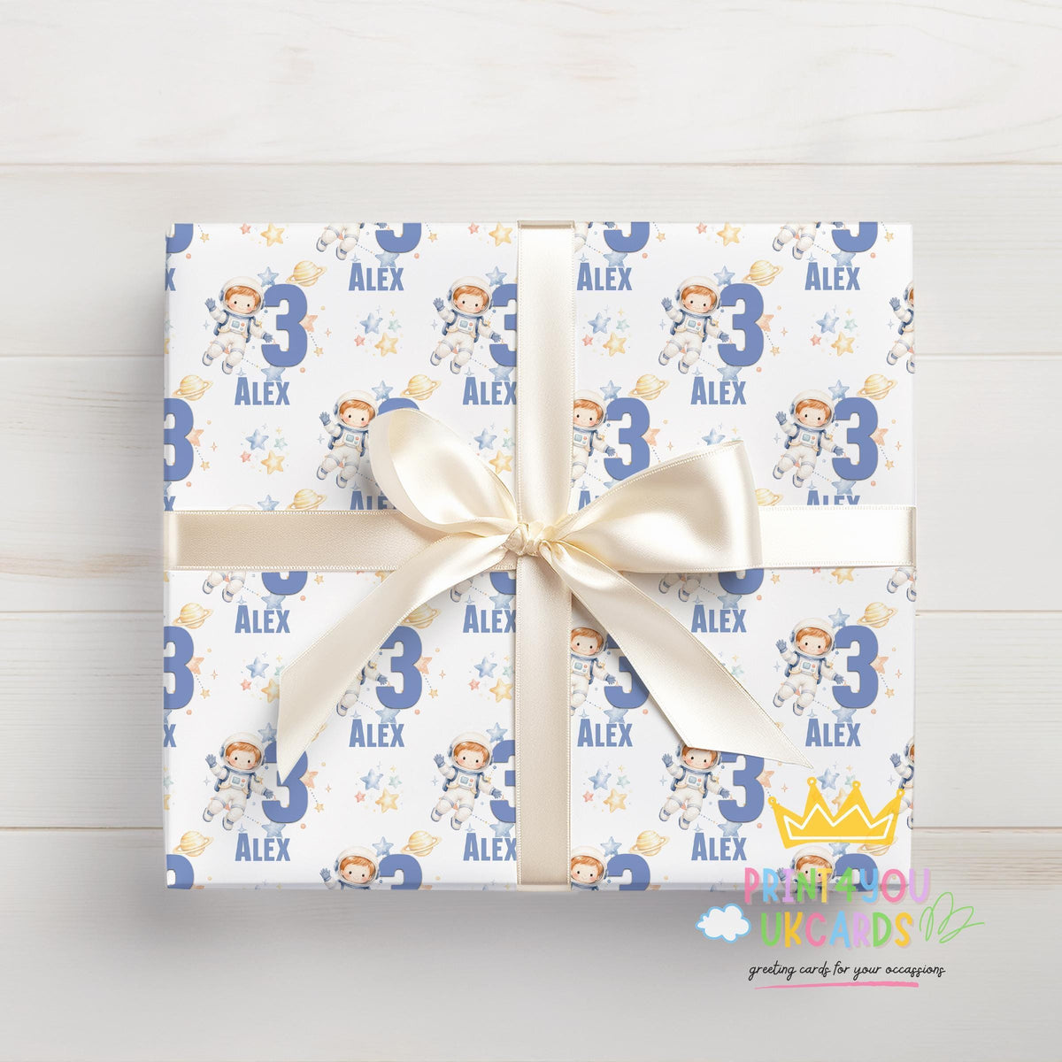 Gift wrapped in the personalised astronaut space wrapping paper, tied with ribbon.