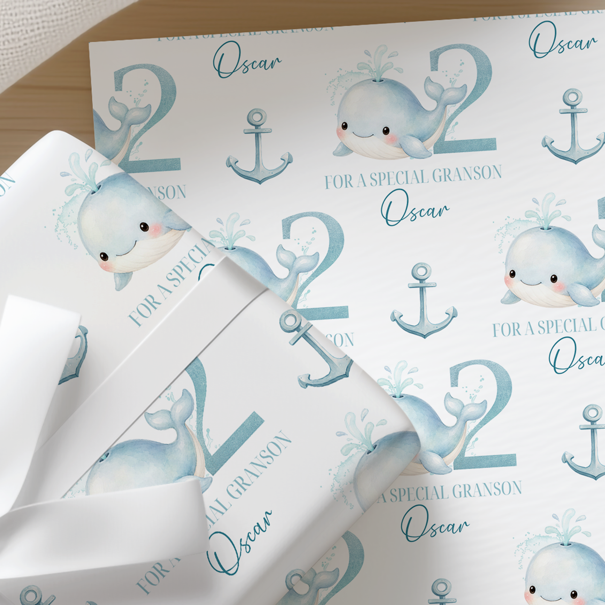 Personalised whale and anchor wrapping paper example printed with the name Oscar and age 2