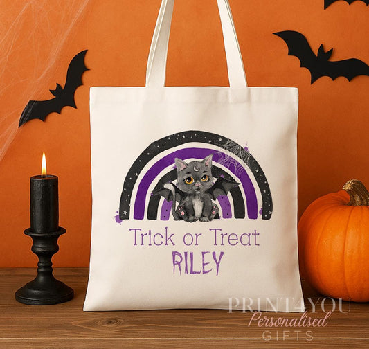 Personalised Halloween tote bag with a black cat and bat wings design and a custom child's name printed in rainbow colours