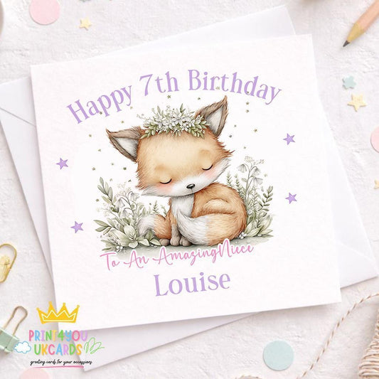 White square birthday card featuring an illustrated sleeping fox wearing a flower crown among woodland leaves and stars, personalised with '7th Birthday', 'To An Amazing Niece' and the name Louise, styled with a white envelope, confetti and a pencil
