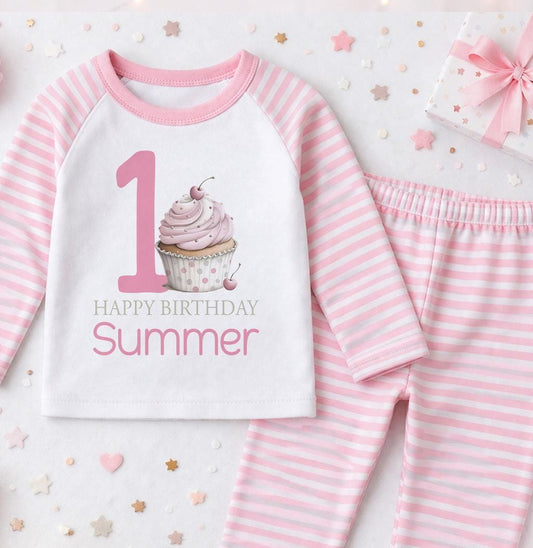 Personalised first birthday pyjamas with pink cupcake design and custom name, soft cotton