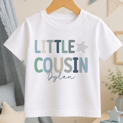 A white t-shirt with the text "LITTLE COUSIN Dylan" printed on it.