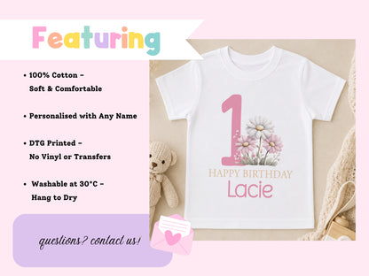 Personalised pink floral first birthday t-shirt displayed with a teddy bear