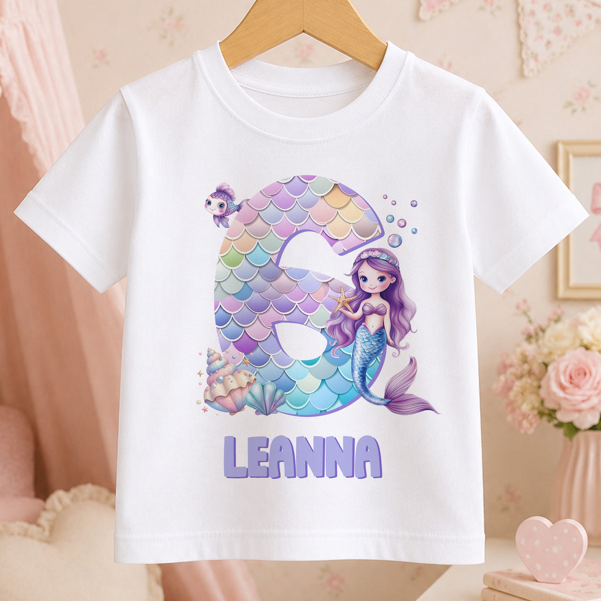 Personalised mermaid design t-shirt for girls in white cotton, printed with an example name to show the personalisation.