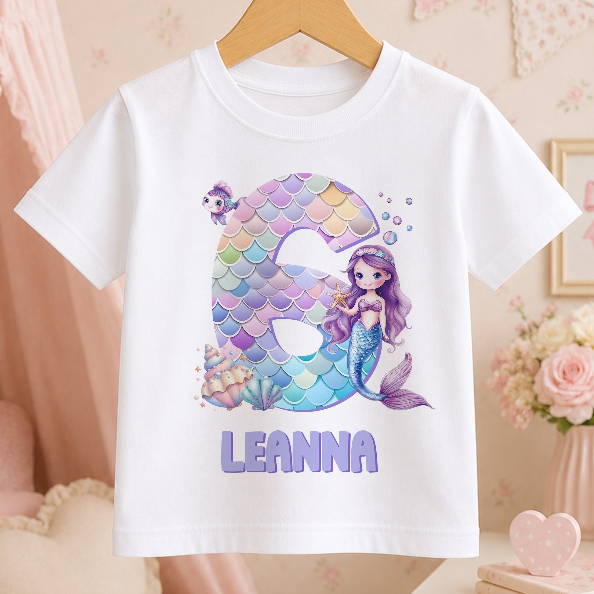 Personalised mermaid design t-shirt for girls in white cotton, printed with an example name to show the personalisation.