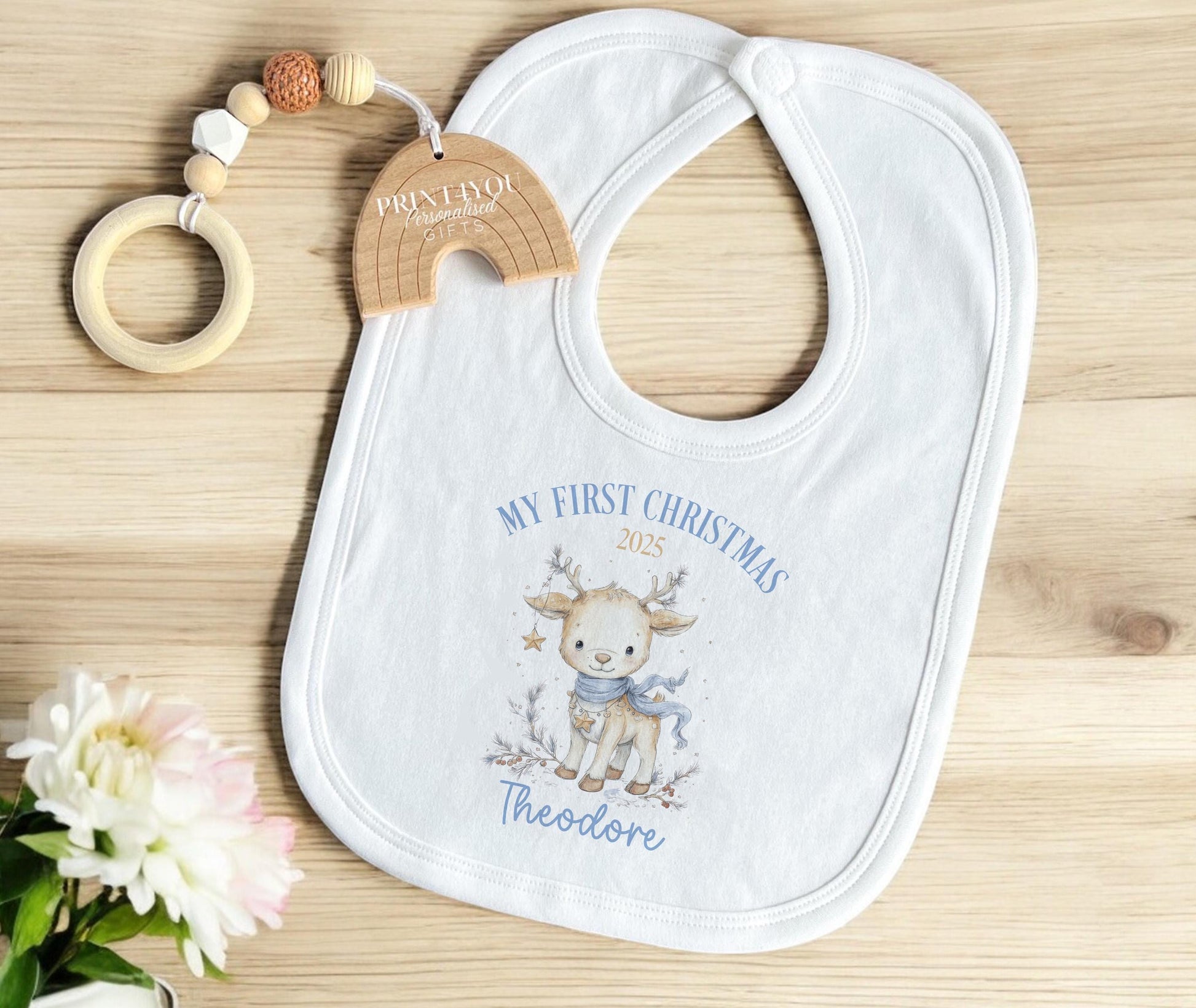 Personalised Christmas baby bib with reindeer design and custom name.