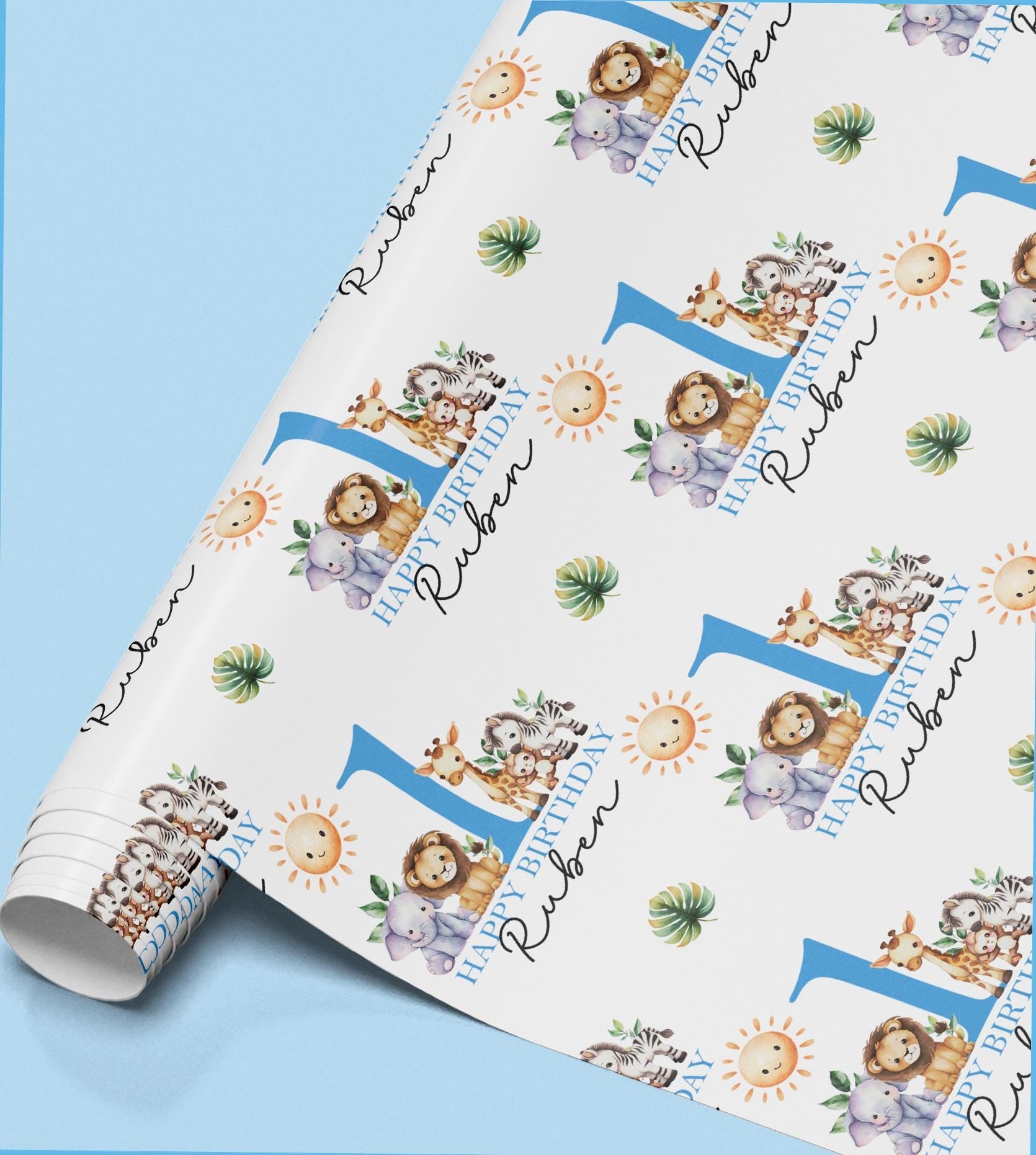 The image is a roll of wrapping paper with a repeating pattern of a blue number 1 and various animal illustrations, including a lion, giraffe, and elephant.