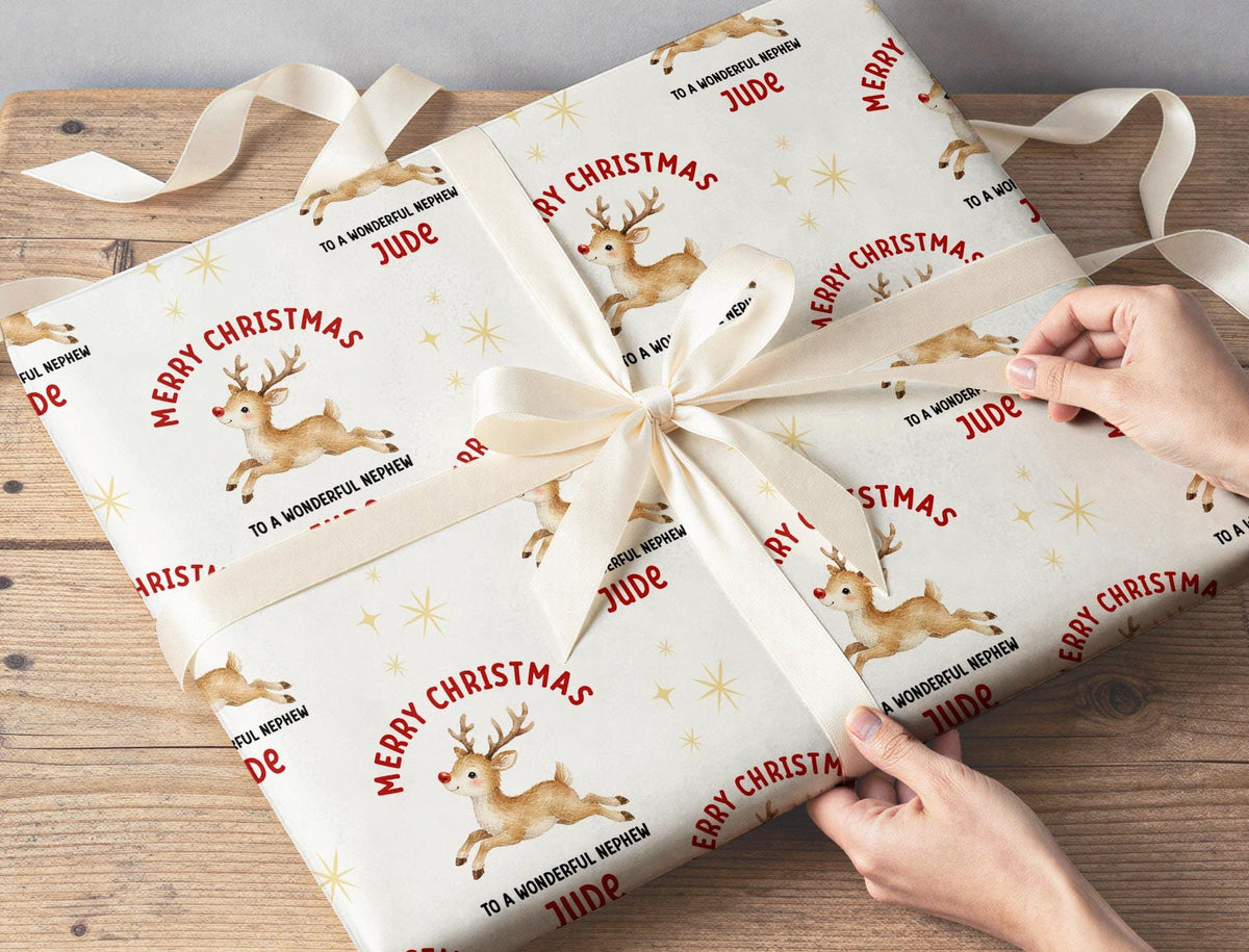 Personalised reindeer wrapping paper roll shown with custom name example