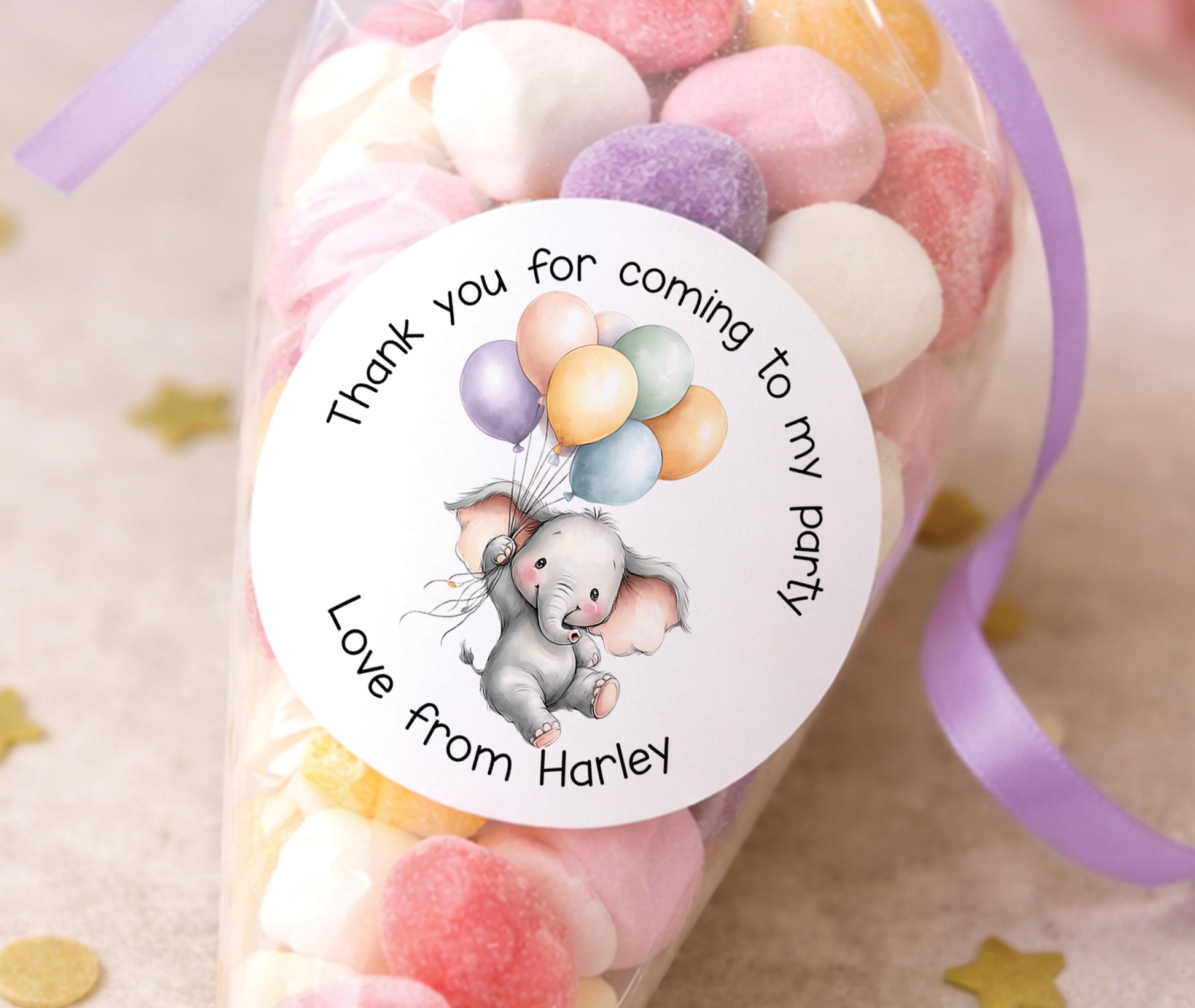Round glossy elephant birthday stickers printed with a child's name for safari-themed party bags