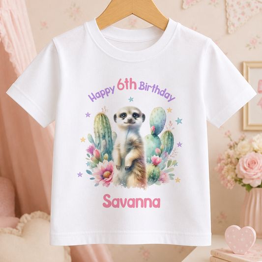 White children's t-shirt personalised with a meerkat design among cacti and flowers, and a custom birthday name and age