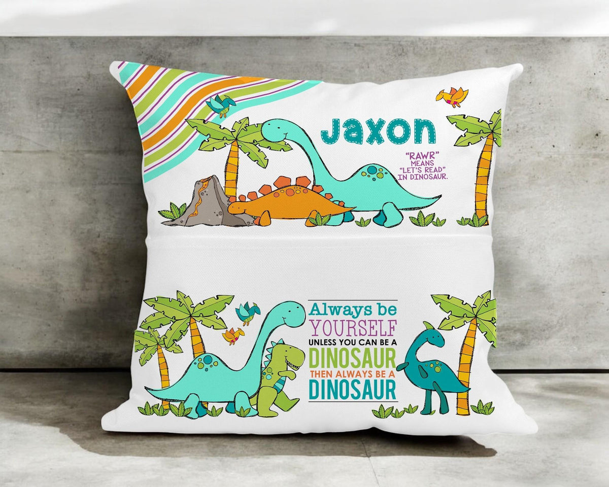 Soft velvet dinosaur cushion with palm tree and stripe design in a child's reading nook