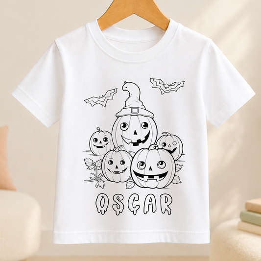 A white t-shirt with a black and white illustration of a group of smiling jack-o-lanterns, along with bats flying above them. The word "OSCAR" is written below the illustration.