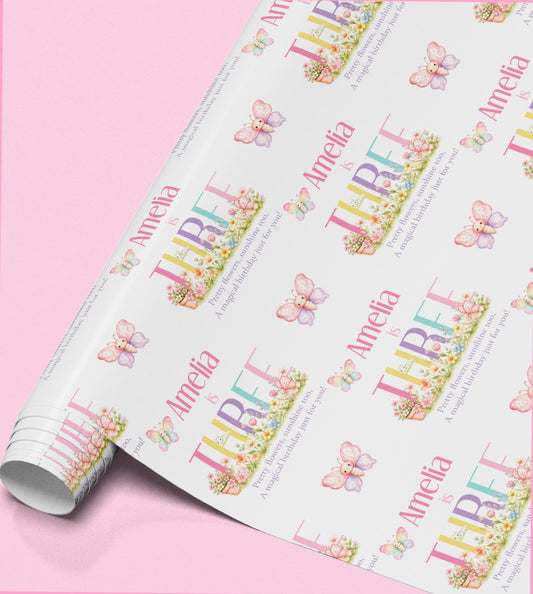 Roll of butterfly wrapping paper personalised with the name Amelia.