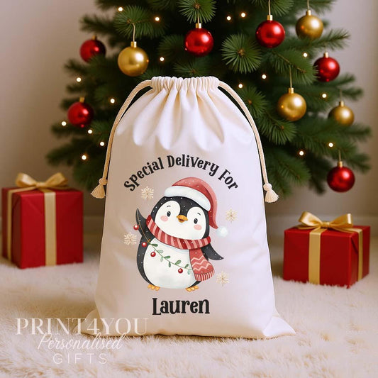 Personalised penguin Christmas sack, cream cotton drawstring santa sack printed with a penguin in a Santa hat and Special Delivery For a name