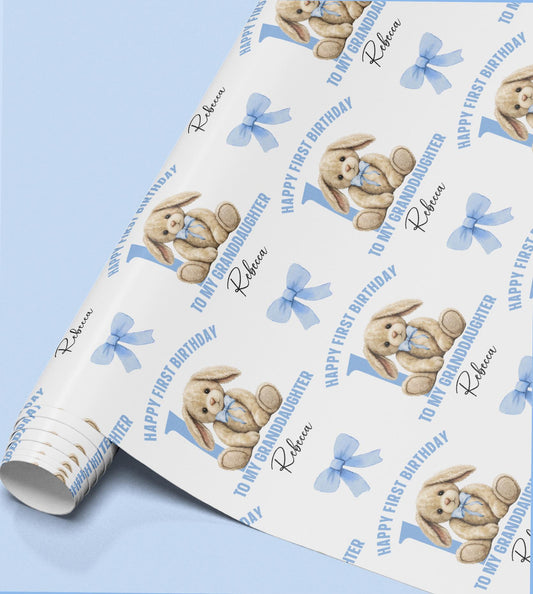 Close-up of the pastel blue bunny wrapping paper pattern, personalised with a custom name.