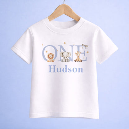 Personalised jungle safari first birthday bodysuit with a giraffe, elephant and lion design and custom name printed underneath.