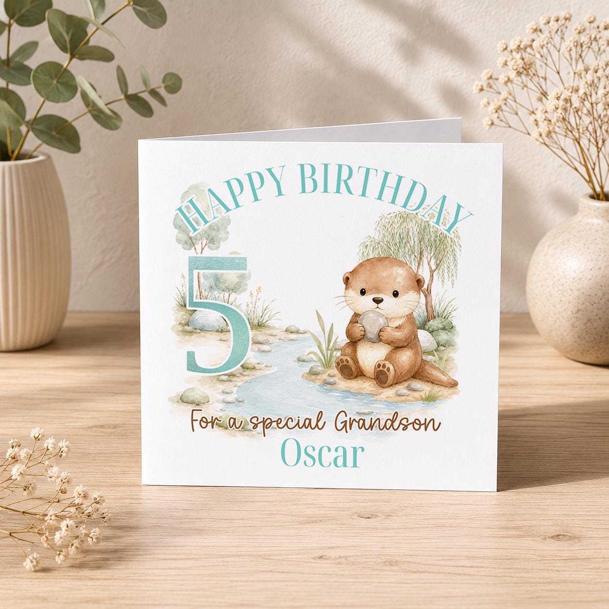 Square greeting card showing the otter birthday card design