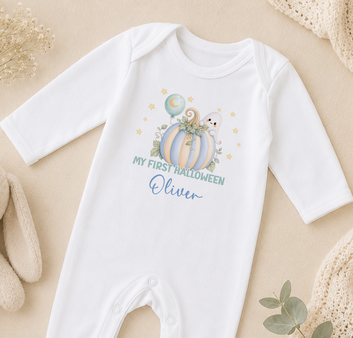 A white onesie with a Halloween-themed design, including a pumpkin, ghost, and stars, along with the text "My first Halloween Oliver".