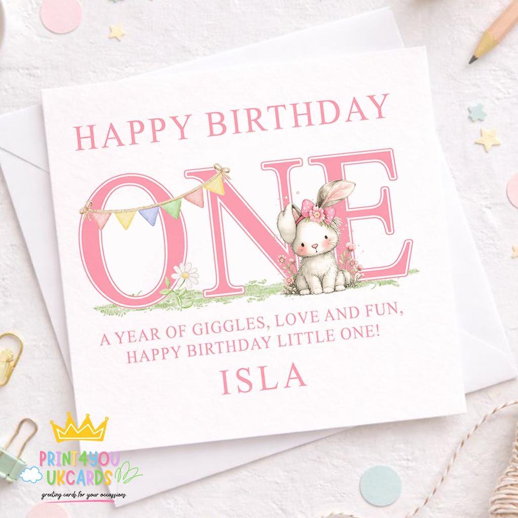 Square first birthday greeting card shown at an angle to display the pink bunny design and card stock.