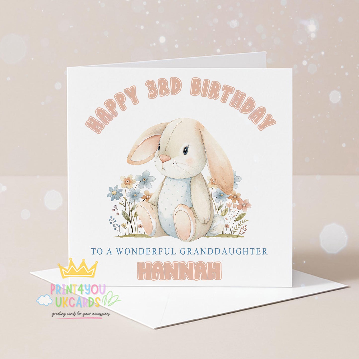 Square personalised birthday card featuring an illustrated bunny surrounded by pastel florals, with space for a printed name and age