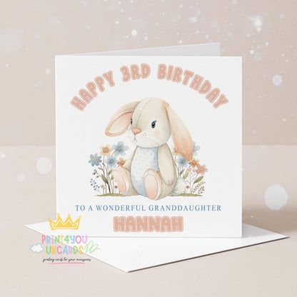 Square personalised birthday card featuring an illustrated bunny surrounded by pastel florals, with space for a printed name and age