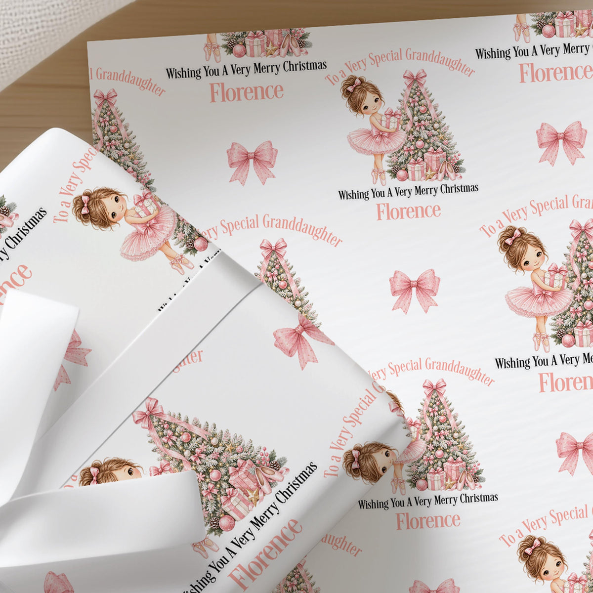 Sheets of the personalised ballerina Christmas wrapping paper ready to wrap