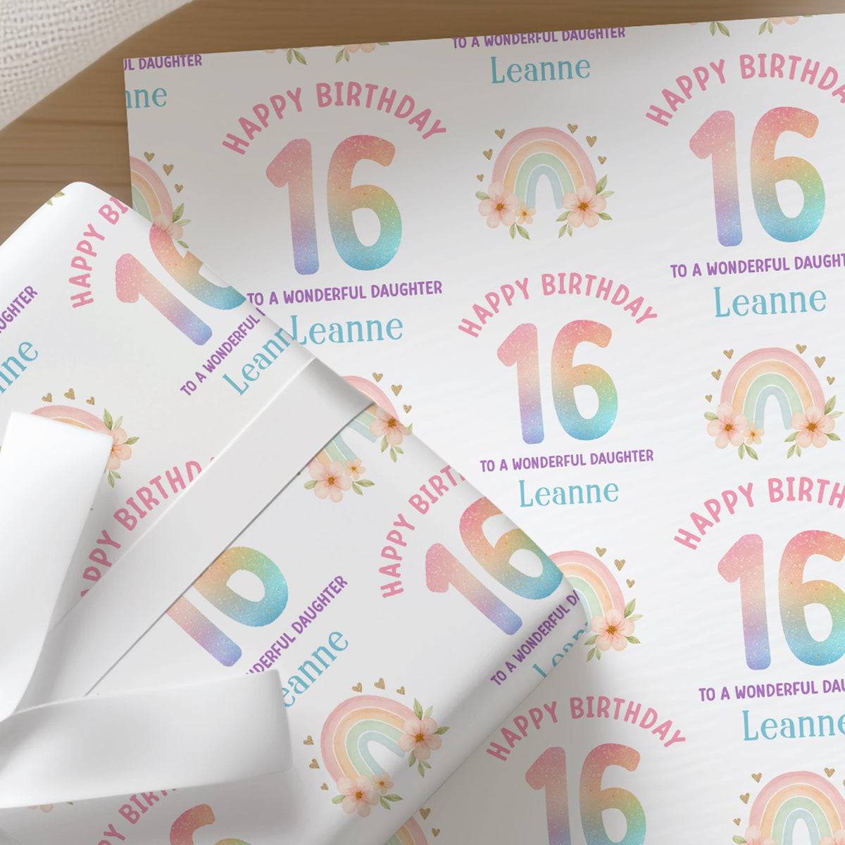 Personalised rainbow birthday wrapping paper featuring a soft pastel rainbow, custom name, age and relation, colourful birthday gift wrap.