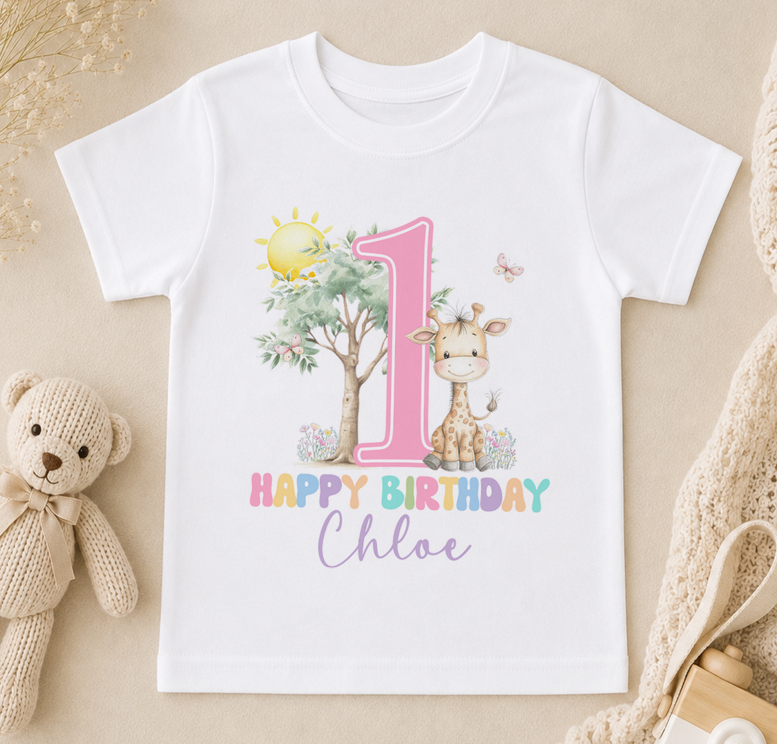 A white t-shirt with a pink number one and a giraffe, along with the text "Happy Birthday Chloe" printed on it.