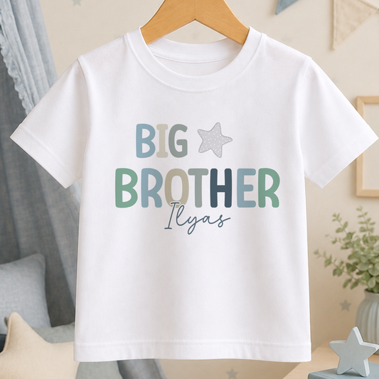 A white t-shirt with the text "BIG BROTHER ILYAS" printed on it, along with a small star symbol.